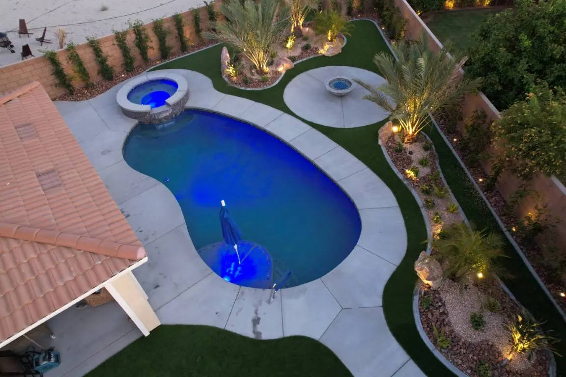 Blue-lit freeform pool seen from above