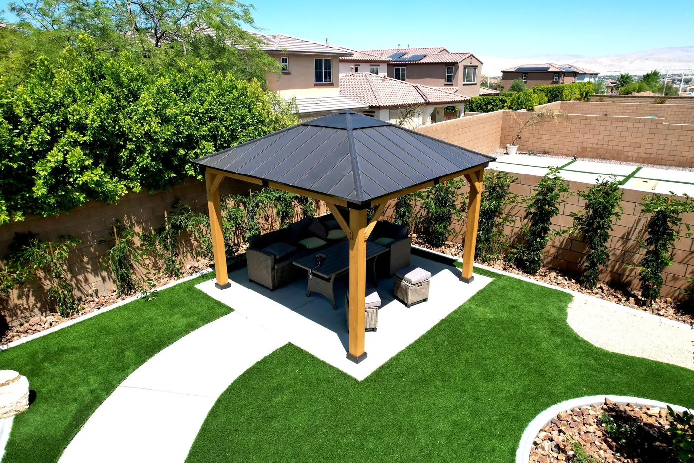 Gazebo and curved pathways around a backyard pool
