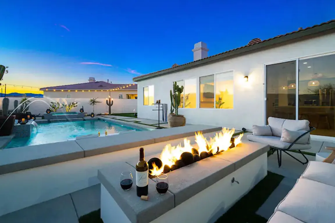 Fire feature and pool at a short-term rental at sunset