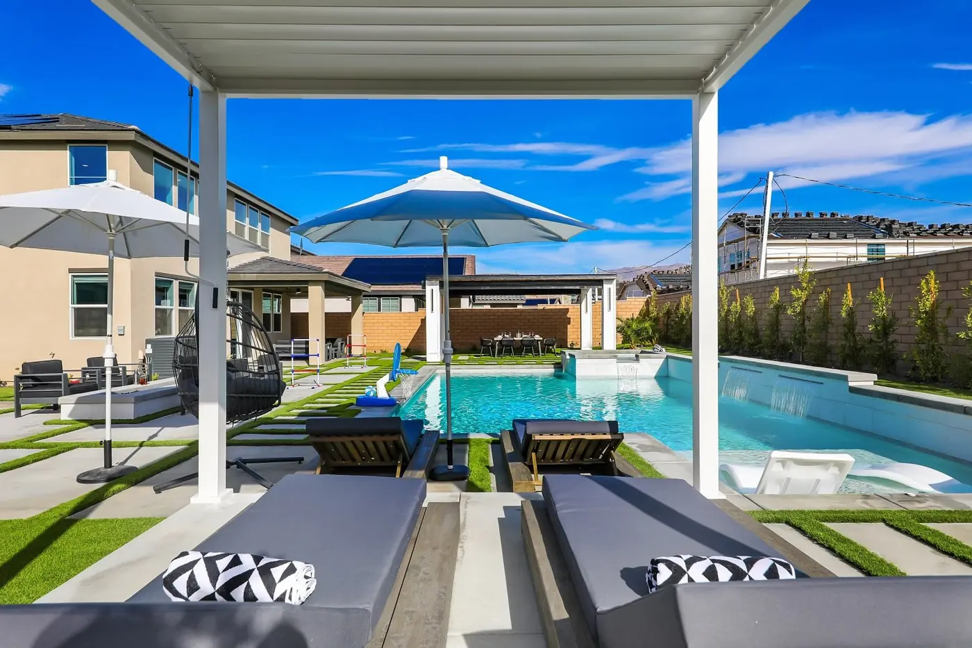Shaded daybeds overlooking a pool