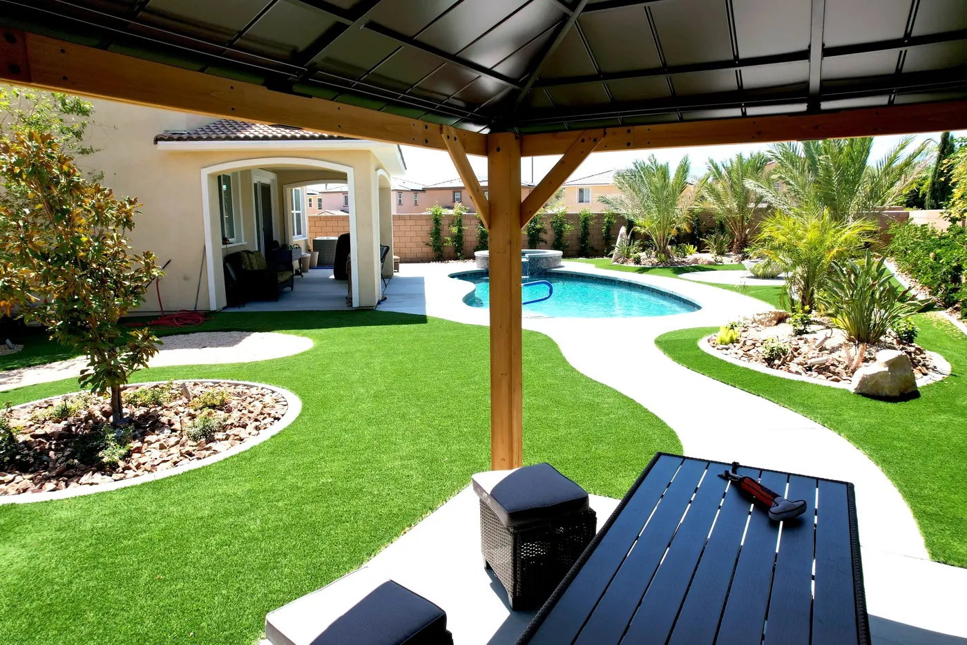 Gazebo and curved turf paths beside a freeform pool