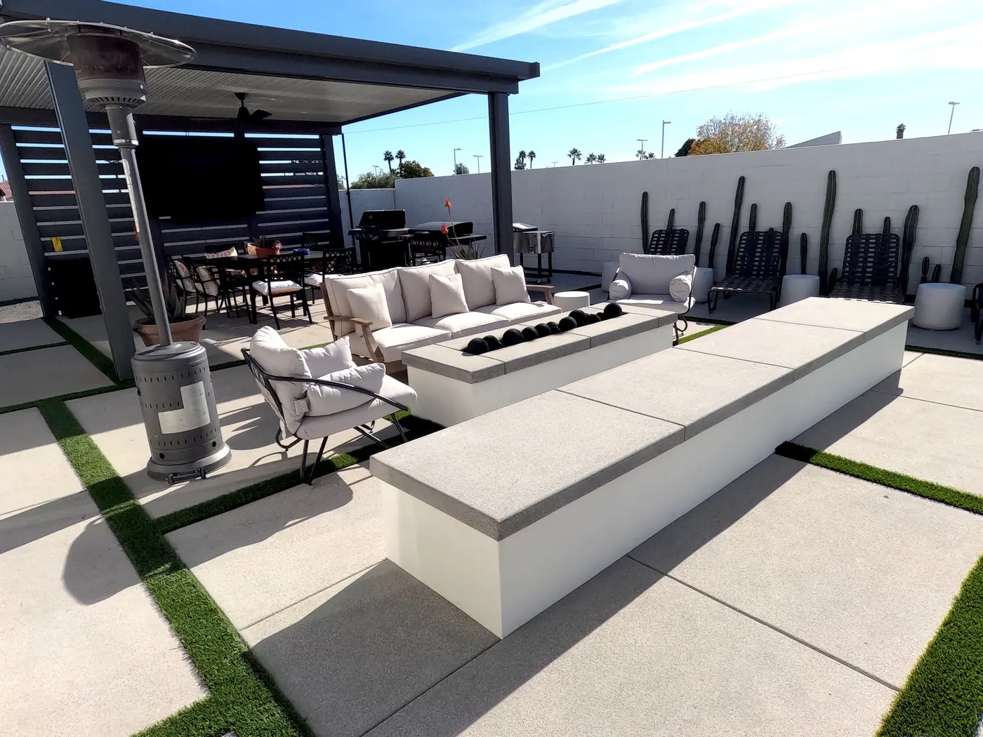 Outdoor sofa and long concrete fire bench