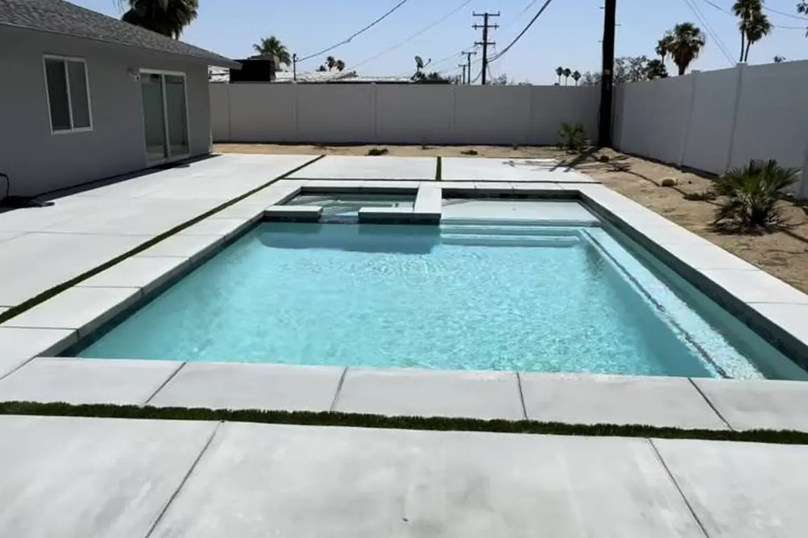 Clean modern rectangular pool in a compact backyard